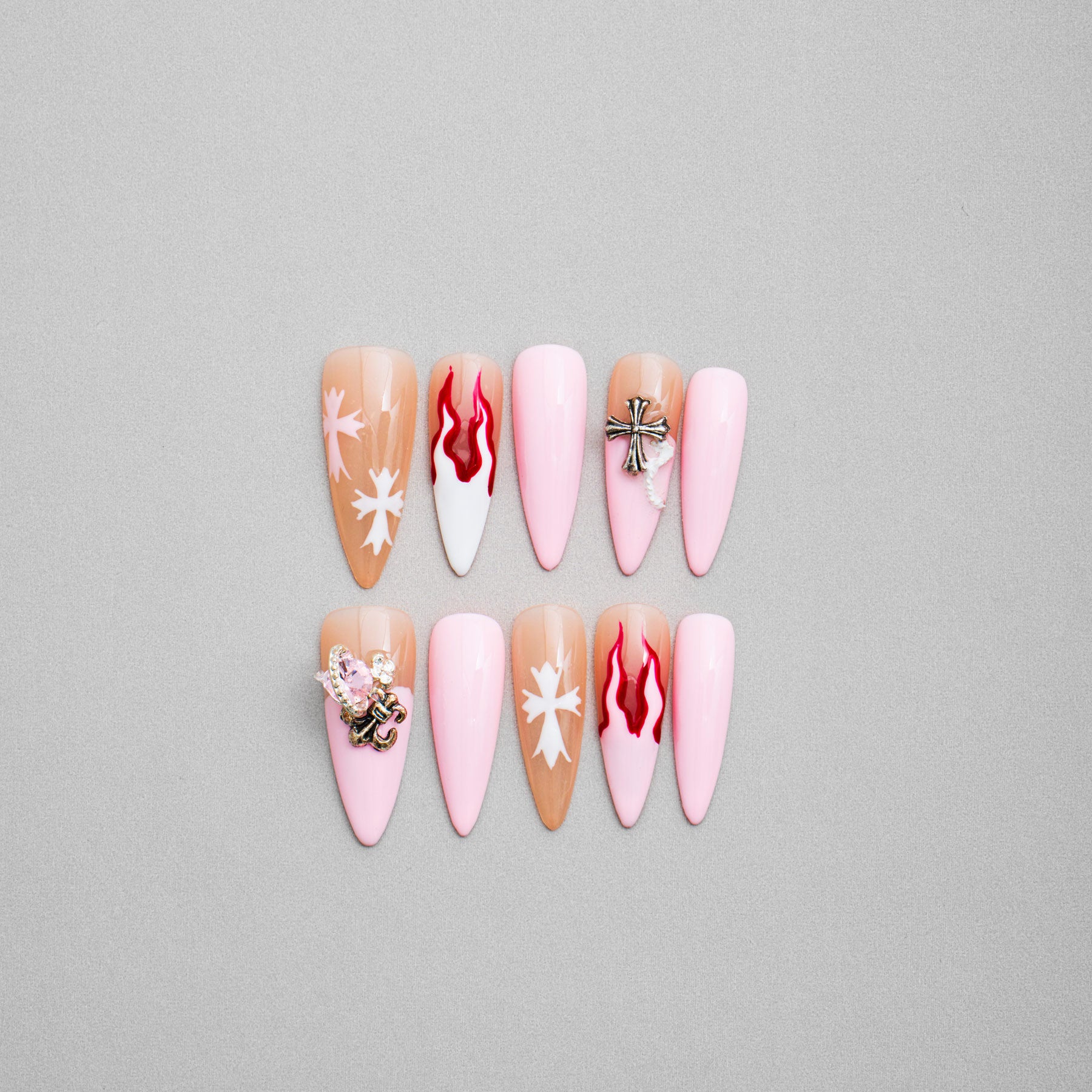 Veloria Beauty "Punk Princess" Stiletto Shaped Handmade Press On Nails - Press-on nails in a stiletto shape with bold pink hues, featuring edgy flames and striking crosses for a rebellious and fierce look